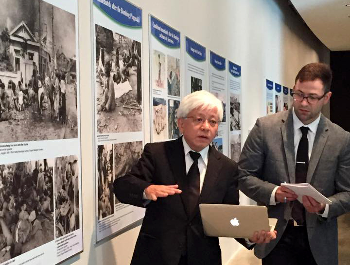 Dr. Kenji Shiga and his translator at the AU exhibition